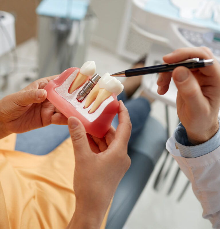 close up of patient and doctor going over a dental implants in Cary model within the dental center