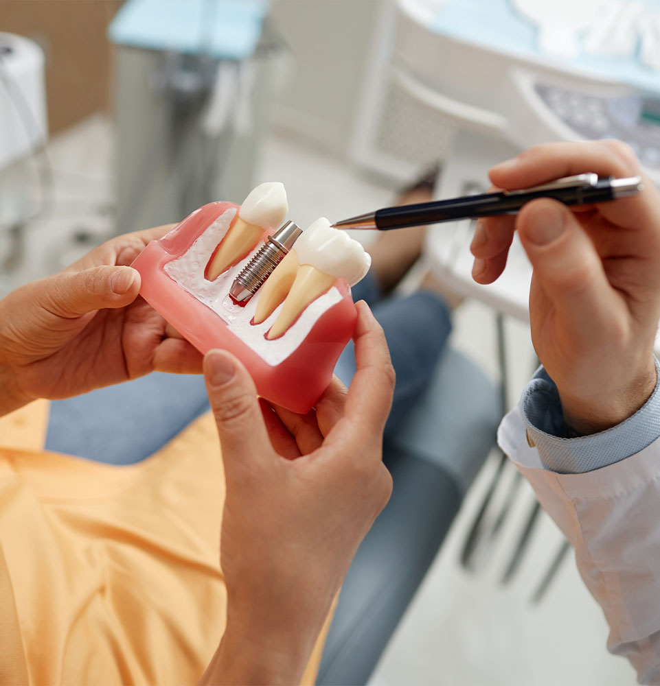 close up of patient and doctor going over a dental implants in Cary model within the dental center